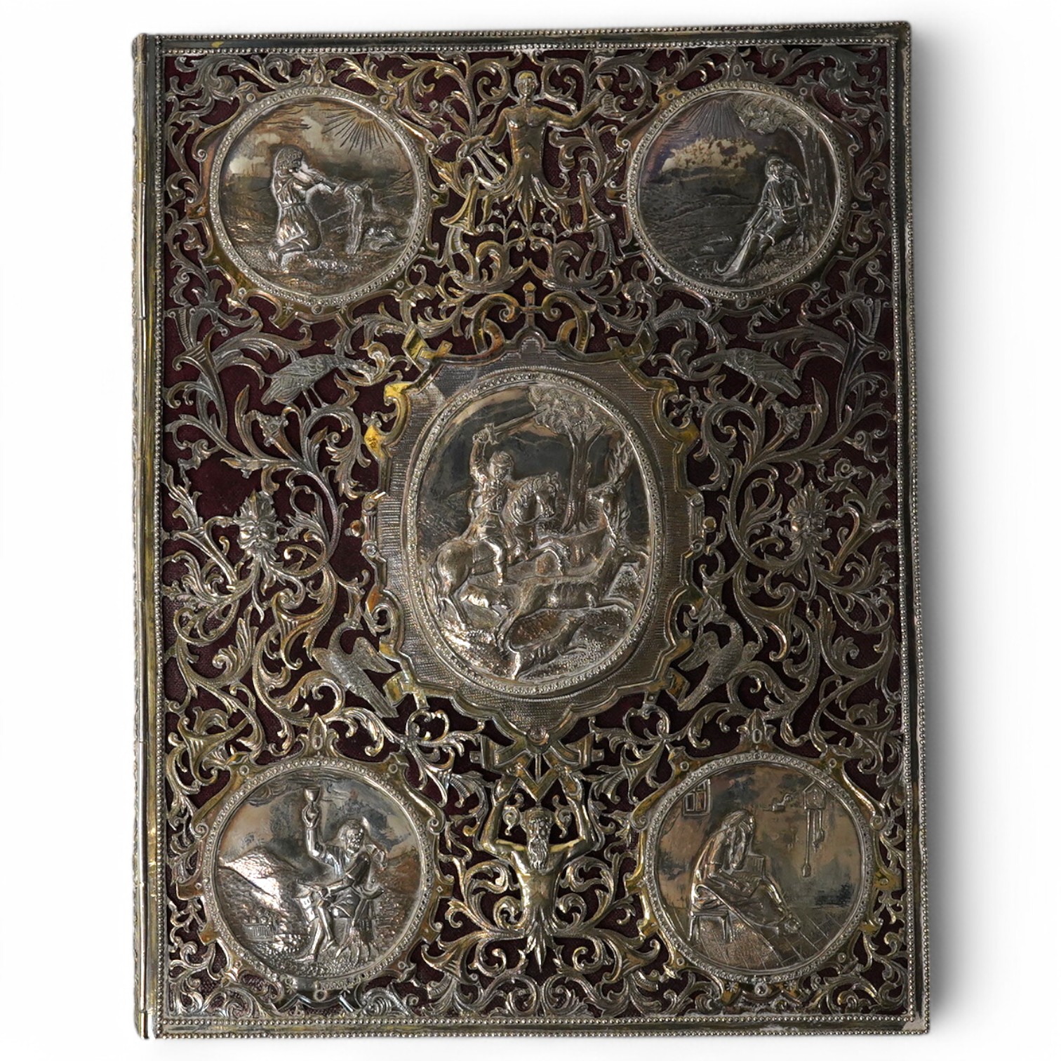 A white metal mounted rectangular desk folder, with beaded borders and pierced and decorated with scrolling foliage, birds and oval panels depicting figures at various pursuits, stamped '13', 30.6cm. Condition - poor to